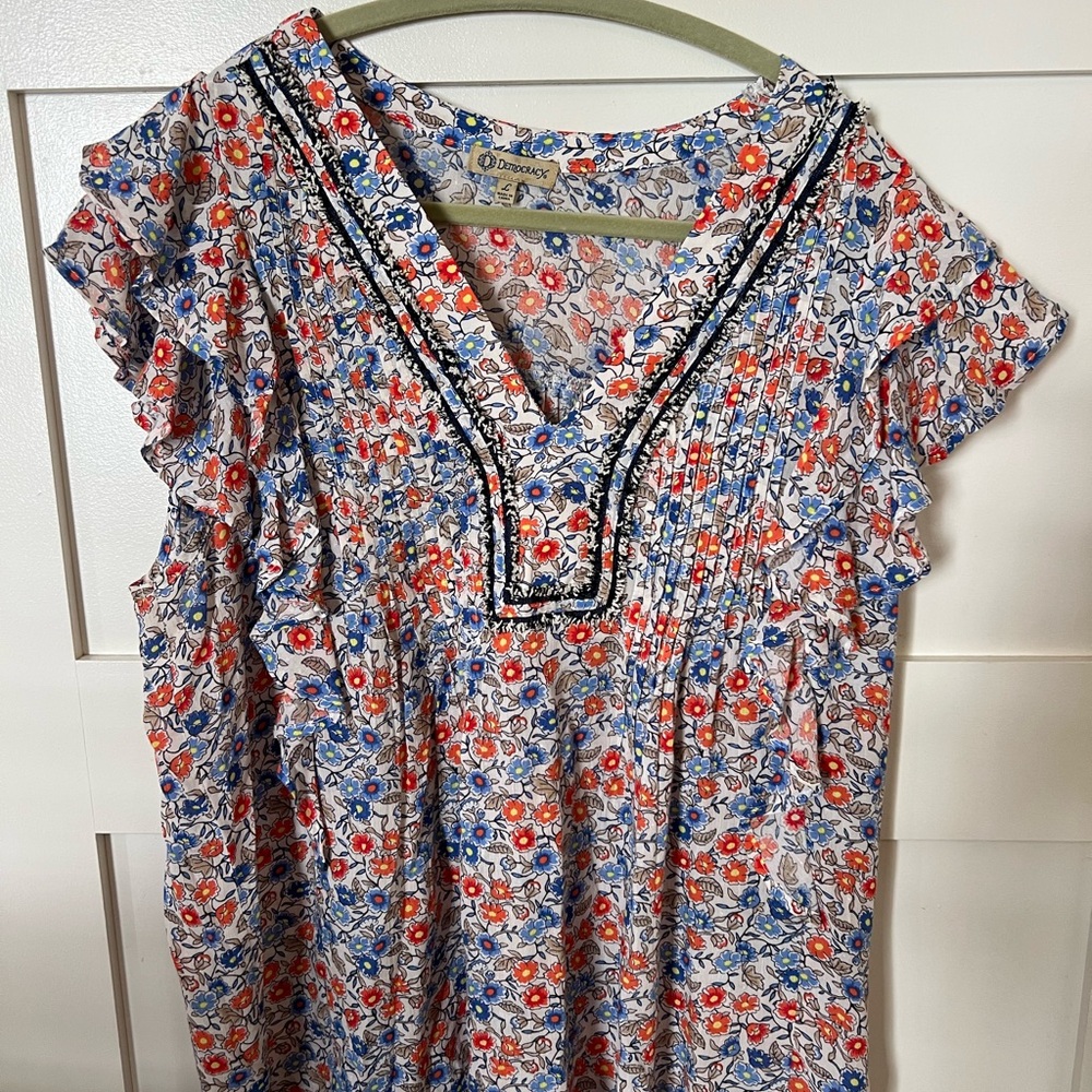 Democracy adorable top with flutter sleeve caps.
